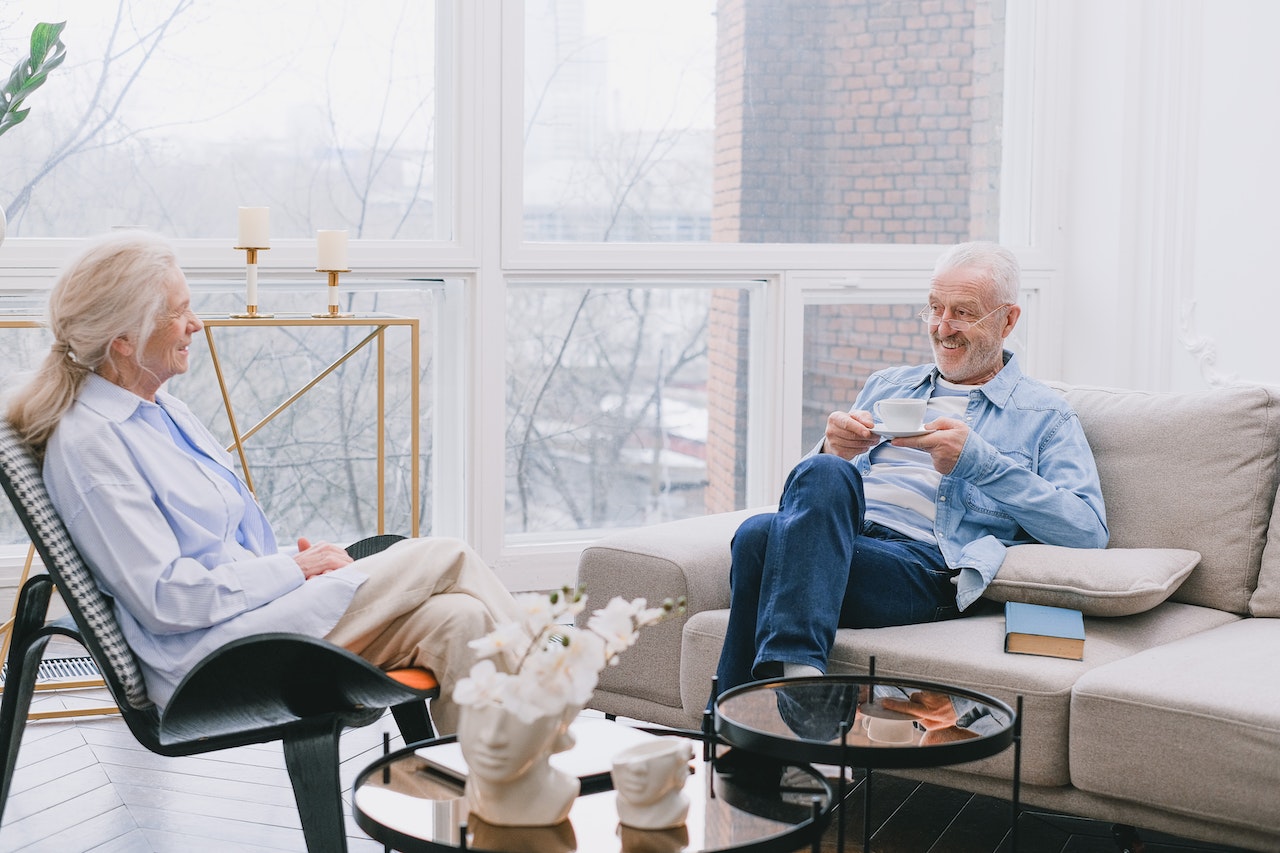 elderly couple enjoying tea at their home