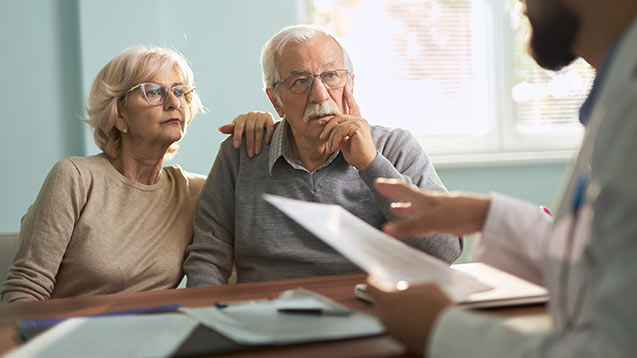 Senior couple talking to an agent