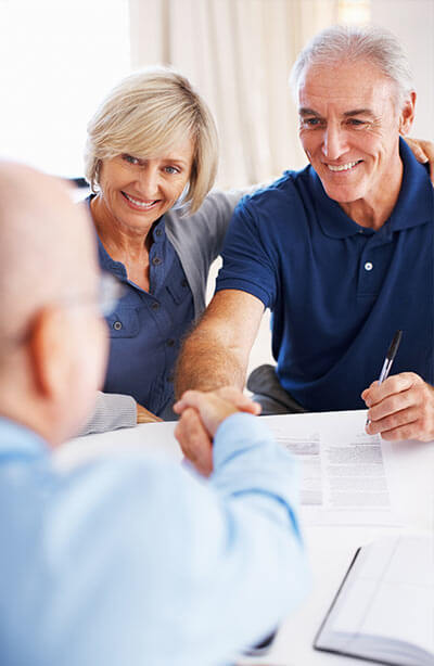 Seniors citizen shaking hands with reverse mortage broker