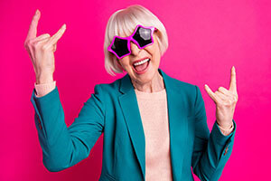 happy senior with rock on sign