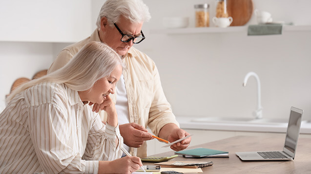 Seniors citizen couple in front of a laptop